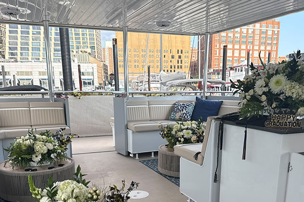 Interior lounge of the Skyline catamaran with a waterfront city view at Chelsea Piers in New York