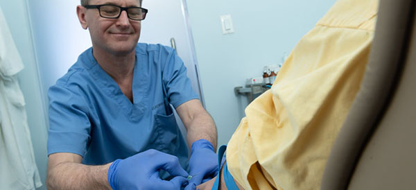 Dr. Alexeyenko administers an IV therapy treatment at his office in NYC. Here the patient relaxes in the lounge while receiving treatment. 