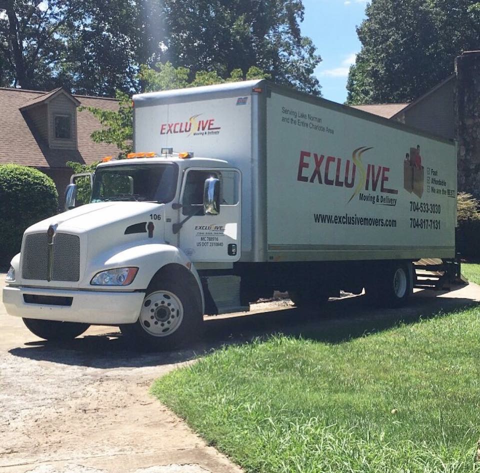 Exclusive Movers Moving Truck in Driveway