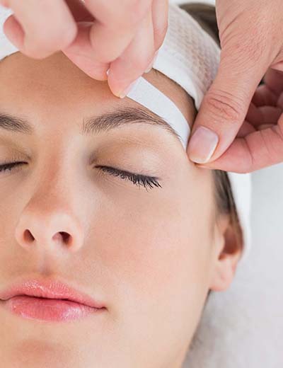 eyebrow being waxed at skin care clinic in New York, NY